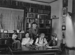 Roy Newton in office with students.