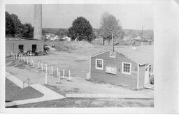 Heating plant with smokestack chimney and surrounding buildings. Undated photo.