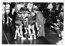 Coach Jim Wink in huddle at basketball game. Undated photo.